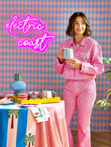 Eleanor Bowmer holding a Blue Wave Mug